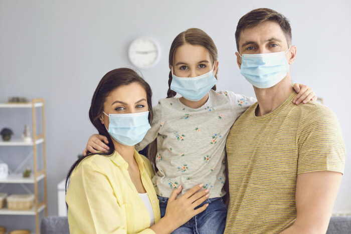 Which COVID-19 test do I need to travel? 6 Family In Medical Masks On The 361351642 1