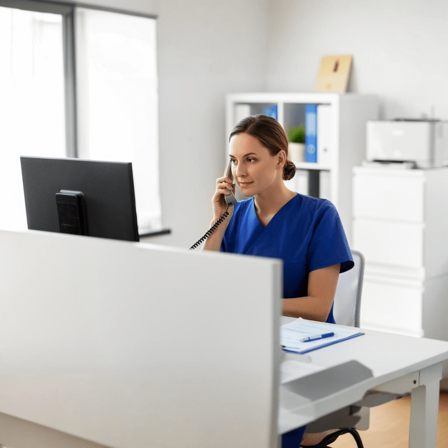 doctor with computer calling phone hospital square