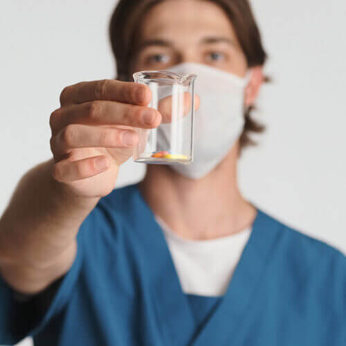 Male nurse holding antibiotics.