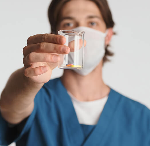 Male nurse holding antibiotics.