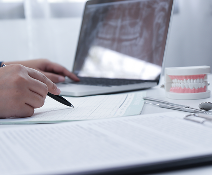 cropped image dentist working laptop desk 1